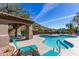 Community pool with lounge chairs and a covered patio area at 3236 E Chandler Blvd # 2033, Phoenix, AZ 85048