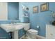 Light and airy powder room with pedestal sink and white fixtures at 3415 E Sports Dr, Gilbert, AZ 85298