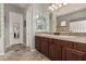 Double vanity bathroom with wood cabinets and tile flooring at 3415 E Sports Dr, Gilbert, AZ 85298