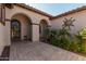 Inviting entryway with arched doorways, tile flooring, and a decorative sun wall art piece at 3415 E Sports Dr, Gilbert, AZ 85298