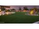 Expansive backyard with artificial turf and landscape lighting at 4547 S Banning Dr, Gilbert, AZ 85297