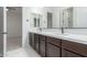 Modern bathroom with double vanity and dark wood cabinets at 4547 S Banning Dr, Gilbert, AZ 85297