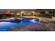 Inviting pool and spa with a rock waterfall feature at night at 4547 S Banning Dr, Gilbert, AZ 85297