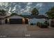 Charming house with dark-colored garage door and updated landscaping at 6262 N 85Th St, Scottsdale, AZ 85250