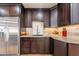 Modern kitchen with dark wood cabinets and granite countertops at 6262 N 85Th St, Scottsdale, AZ 85250