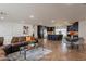 Open living room featuring a leather couch, coffee table, and view into the kitchen at 6262 N 85Th St, Scottsdale, AZ 85250