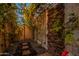 Private outdoor shower with stone wall and lush landscaping at 6262 N 85Th St, Scottsdale, AZ 85250