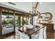 Rustic-chic dining room with chandelier and patio view at 9515 E Sundance Trl, Scottsdale, AZ 85262