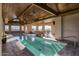 Indoor pool with wood ceiling and stone floor at 9515 E Sundance Trl, Scottsdale, AZ 85262