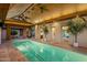 Indoor lap pool with high ceilings and wood beams at 9515 E Sundance Trl, Scottsdale, AZ 85262