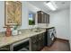 Laundry room with granite countertop and built-in cabinets at 9515 E Sundance Trl, Scottsdale, AZ 85262