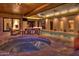 Hot tub and pool at night with wooden ceiling at 9515 E Sundance Trl, Scottsdale, AZ 85262