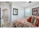 Relaxing bedroom with access to the bathroom and window shutters at 97 E Alcatara Ave, San Tan Valley, AZ 85140