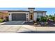 Single-story home with desert landscaping and a two-car garage at 97 E Alcatara Ave, San Tan Valley, AZ 85140