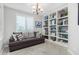 Bright sitting area with built-in shelving and a comfortable couch at 97 E Alcatara Ave, San Tan Valley, AZ 85140