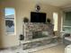 Cozy patio featuring a stone fireplace and comfortable seating at 97 E Alcatara Ave, San Tan Valley, AZ 85140