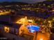 Aerial view of a stunning home with a resort-style backyard at night at 14959 S 184Th Ave, Goodyear, AZ 85338