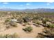 Aerial view of a single-story home on a large desert lot with mountain views at 30247 N 164Th St, Scottsdale, AZ 85262