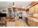 Bright kitchen with wood cabinets, butcher block island, and tiled backsplash at 30247 N 164Th St, Scottsdale, AZ 85262