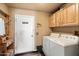 Laundry room with washer, dryer, and built-in cabinets at 30247 N 164Th St, Scottsdale, AZ 85262