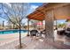 Inviting pool with a pergola, patio furniture, and desert landscape at 30247 N 164Th St, Scottsdale, AZ 85262