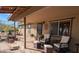 Inviting covered porch with wicker seating and desert plants at 30247 N 164Th St, Scottsdale, AZ 85262