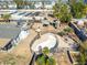 Aerial view of the home with pool (empty), outbuildings, and mature landscaping at 3740 E Edna Ave, Phoenix, AZ 85032