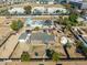 Aerial view of the home, including the pool, other structures on the property, and adjacent land and buildings at 3740 E Edna Ave, Phoenix, AZ 85032