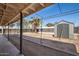 Backyard showcasing storage shed and mature trees at 3740 E Edna Ave, Phoenix, AZ 85032