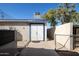 Side exterior view of a block building with dual doors and chain link fence enclosure at 3740 E Edna Ave, Phoenix, AZ 85032