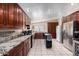 Spacious kitchen with wooden cabinets, granite countertops, and stainless steel appliances at 3740 E Edna Ave, Phoenix, AZ 85032