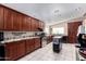 Modern kitchen featuring dark cabinets, stainless steel appliances, and granite countertops at 3740 E Edna Ave, Phoenix, AZ 85032