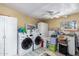 Utility room with washer, dryer, cabinets, and tiled floors at 3740 E Edna Ave, Phoenix, AZ 85032