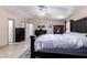 Spacious main bedroom featuring tiled floors, a ceiling fan, and dark wooden furniture at 3740 E Edna Ave, Phoenix, AZ 85032