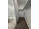 Bathroom with shower and toilet, adjacent to a large closet with shelving at 38085 W Excussare Way, Maricopa, AZ 85138