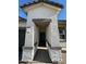 Inviting front entrance with a textured facade, a covered entryway, and stylish stone accents at 38085 W Excussare Way, Maricopa, AZ 85138