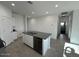 Open kitchen island with granite countertop and stainless steel dishwasher at 38085 W Excussare Way, Maricopa, AZ 85138