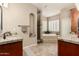 Spa-like bathroom featuring double vanities, a soaking tub, and a separate shower at 3835 E Leland St, Mesa, AZ 85215