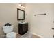 Bathroom featuring a single sink vanity, dark wood cabinets, and classic fixtures at 3835 E Leland St, Mesa, AZ 85215