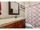 Bathroom featuring vanity with granite countertop, framed mirror, and a shower with patterned curtain at 3835 E Leland St, Mesa, AZ 85215