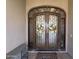 Elegant double front doors with ornate ironwork and seasonal wreaths at 3835 E Leland St, Mesa, AZ 85215