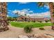 The house has a well maintained lawn, mature trees, and desert landscaping at 3835 E Leland St, Mesa, AZ 85215