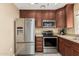 This kitchen features stainless steel appliances, wooden cabinets and granite countertops at 3835 E Leland St, Mesa, AZ 85215