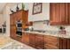 Modern kitchen with stainless steel cooktop and range hood, enhanced by granite countertops at 3835 E Leland St, Mesa, AZ 85215