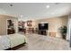 Open concept living room featuring wood look tile floors and kitchen access at 3835 E Leland St, Mesa, AZ 85215