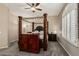 Spacious bedroom with a four-poster bed frame, ceiling fan, and neutral walls at 3835 E Leland St, Mesa, AZ 85215