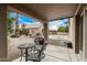 Outdoor patio with table and chairs overlooking the backyard and a neighboring house at 3835 E Leland St, Mesa, AZ 85215