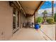 A spacious outdoor patio featuring French doors, a dining table, and lush landscaping at 3835 E Leland St, Mesa, AZ 85215