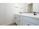 Modern bathroom featuring dual sinks, white cabinets, and sleek black hardware at 3909 E Gold Mountain Ave, San Tan Valley, AZ 85143