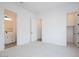 Well-lit bedroom with carpet flooring and access to both a bathroom and a closet at 3909 E Gold Mountain Ave, San Tan Valley, AZ 85143